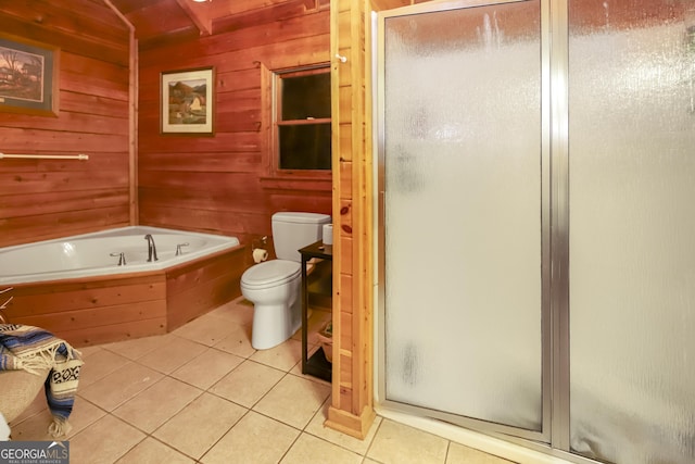 bathroom with tile patterned floors, wood walls, independent shower and bath, and toilet