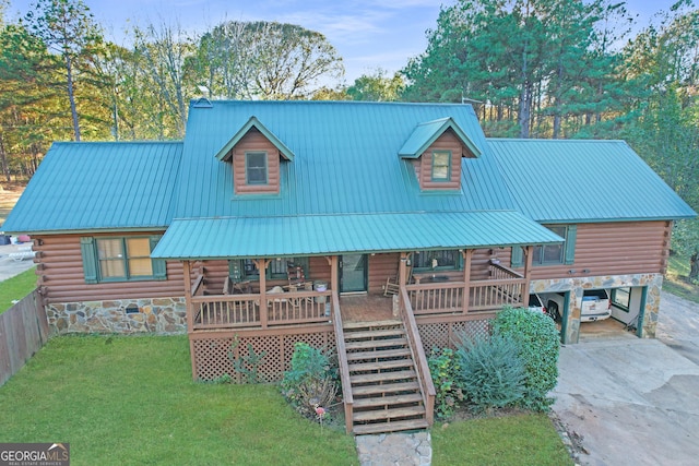 log cabin featuring a porch and a front yard