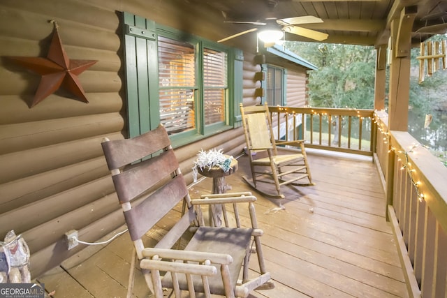 wooden terrace with ceiling fan and a porch