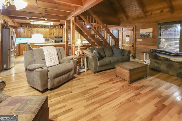 living room with beam ceiling, wooden walls, and wooden ceiling