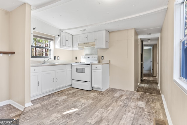 kitchen featuring light hardwood / wood-style floors, range with electric stovetop, white cabinetry, and sink