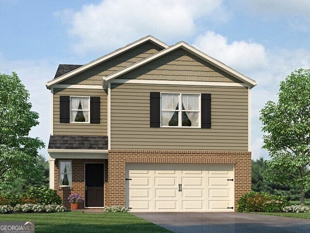 view of front of house with a front yard and a garage