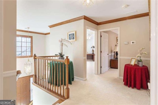 corridor with light colored carpet and crown molding