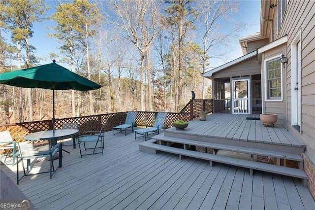 wooden terrace featuring a sunroom