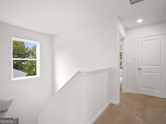 hallway with light carpet