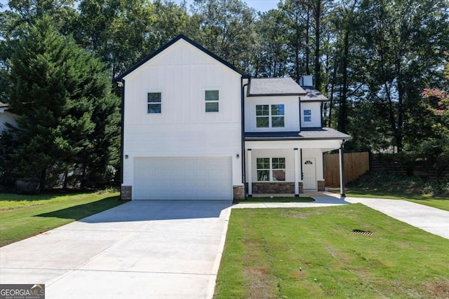 view of front of house with a garage and a front lawn