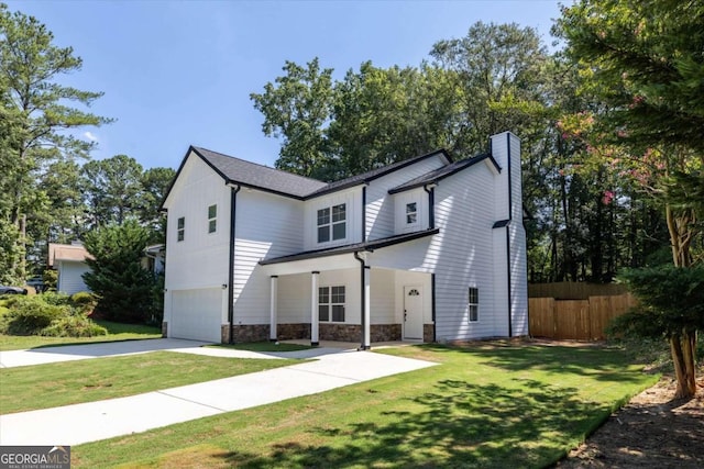 view of front of house with a front lawn and a garage