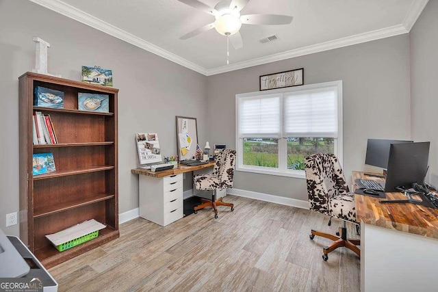 office area with light wood-type flooring, ceiling fan, and ornamental molding