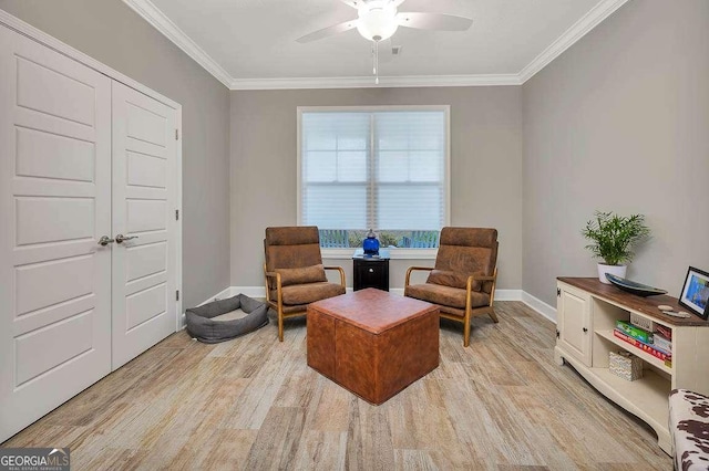 living area featuring ceiling fan, light hardwood / wood-style flooring, and ornamental molding