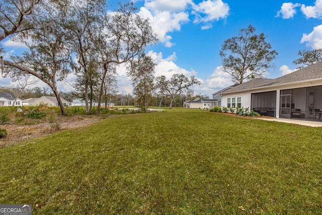 view of yard with a sunroom