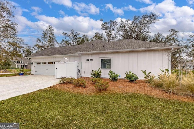 view of front of house with a garage and a front lawn