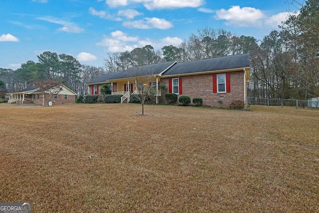 ranch-style house with covered porch and a front lawn