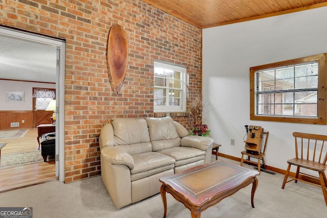 living room featuring light carpet, wood ceiling, brick wall, and ornamental molding