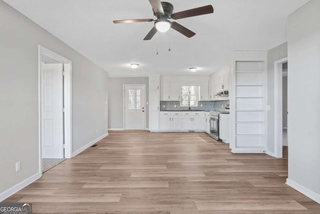 unfurnished living room with light wood-type flooring and ceiling fan