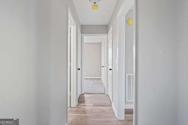 hall with light hardwood / wood-style flooring