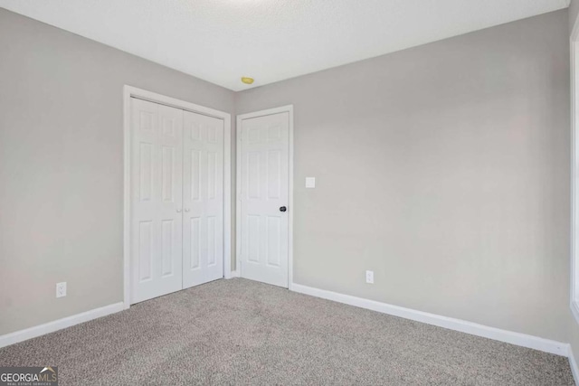 unfurnished bedroom with carpet and a closet