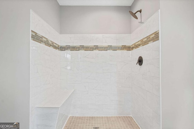 bathroom featuring tiled shower