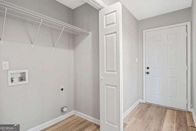 laundry area featuring hookup for an electric dryer, washer hookup, and light hardwood / wood-style flooring