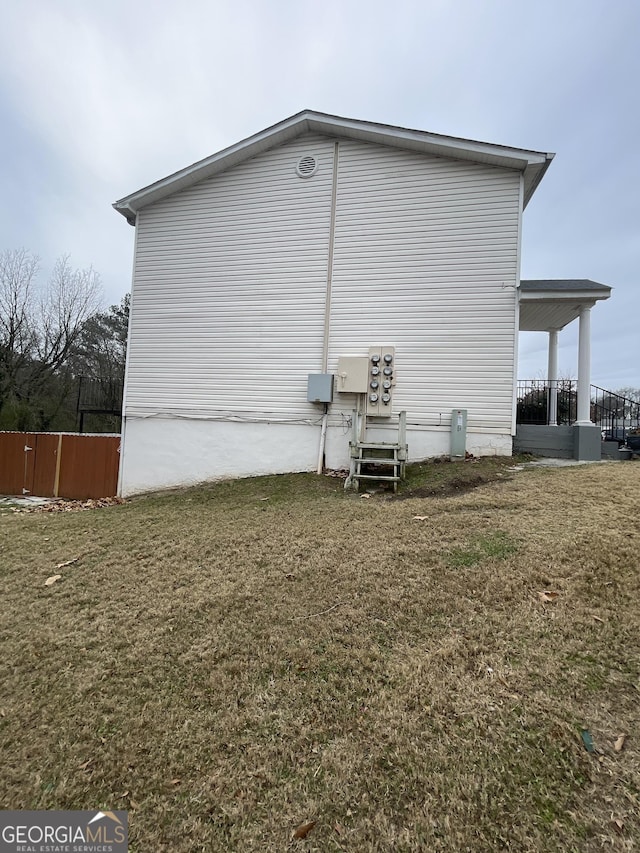 view of side of property with a lawn