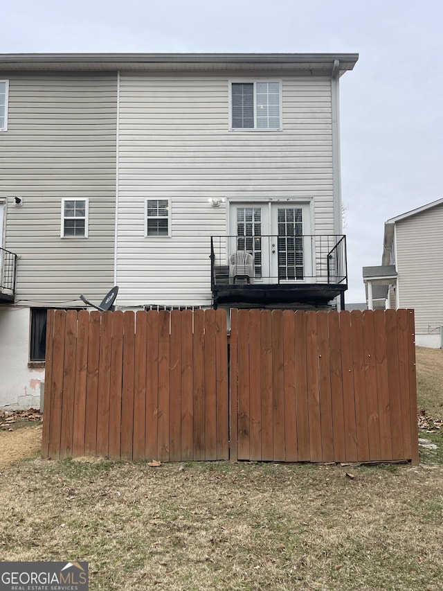 back of property with a balcony