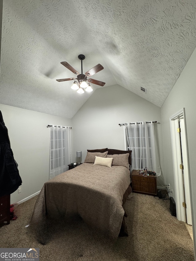 bedroom with carpet, a textured ceiling, ceiling fan, and lofted ceiling