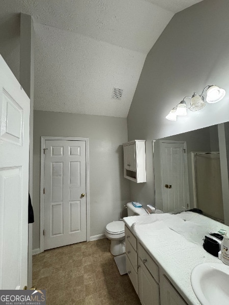 bathroom with walk in shower, a textured ceiling, toilet, lofted ceiling, and vanity