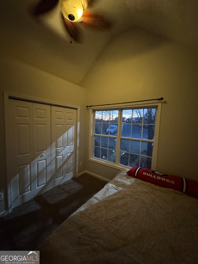 unfurnished bedroom featuring a closet, ceiling fan, and lofted ceiling