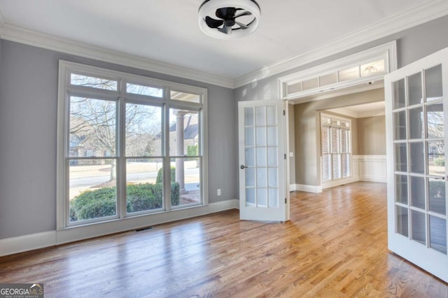 interior space with a wealth of natural light, crown molding, and french doors