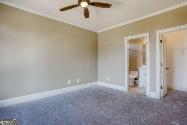 unfurnished bedroom with ceiling fan, a spacious closet, connected bathroom, light colored carpet, and a closet