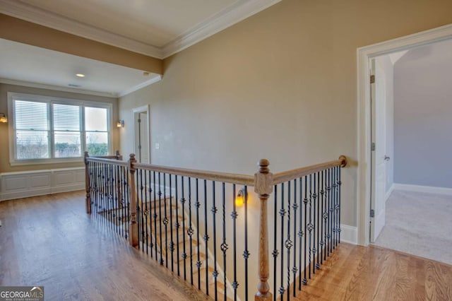 corridor featuring light wood-type flooring and crown molding