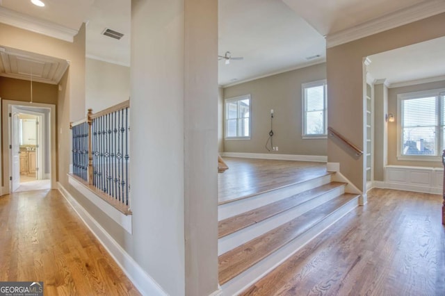 interior space with light wood-type flooring and ornamental molding