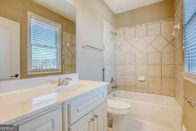 full bathroom with vanity, toilet, and tiled shower / bath combo