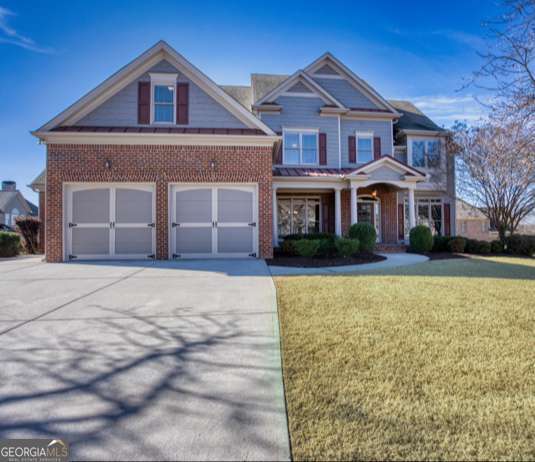 craftsman-style home with a front yard and a garage