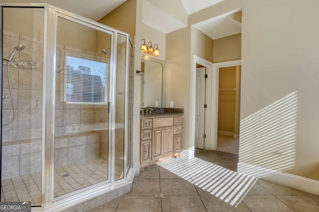 bathroom with tile patterned flooring, vanity, and a shower with door