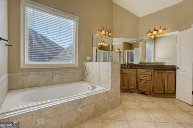 bathroom featuring tile patterned flooring, vanity, and plus walk in shower