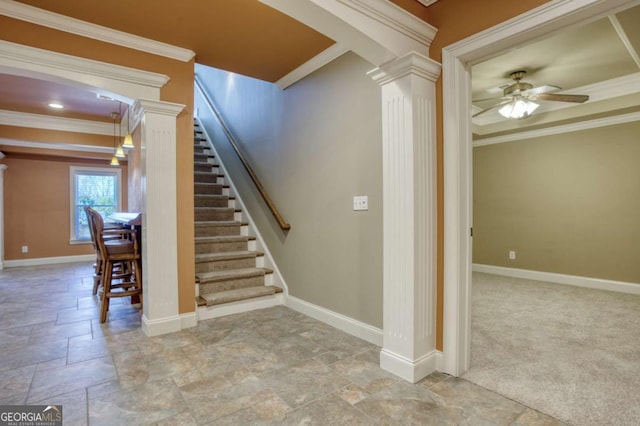 staircase featuring carpet flooring, ceiling fan, ornate columns, and crown molding