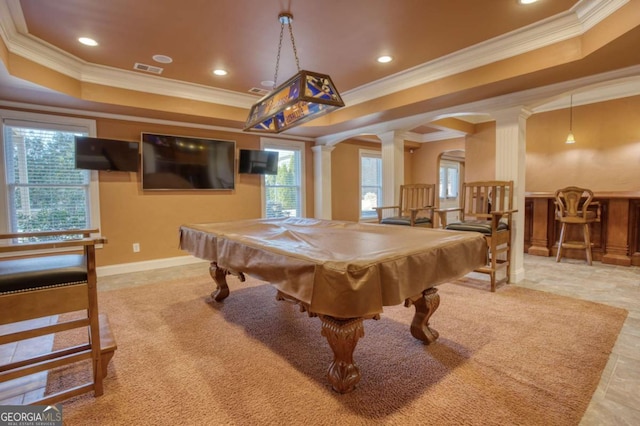 game room with a tray ceiling, ornate columns, crown molding, and pool table