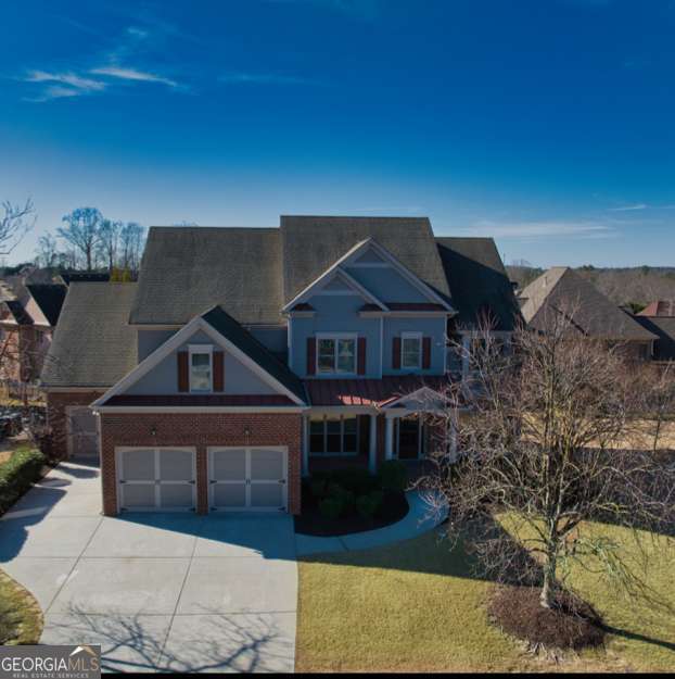 craftsman inspired home with a front yard and a garage