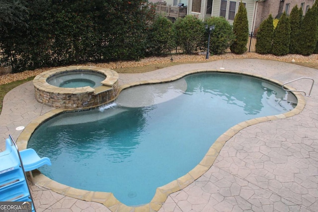 view of pool with an in ground hot tub, a patio, and a water slide