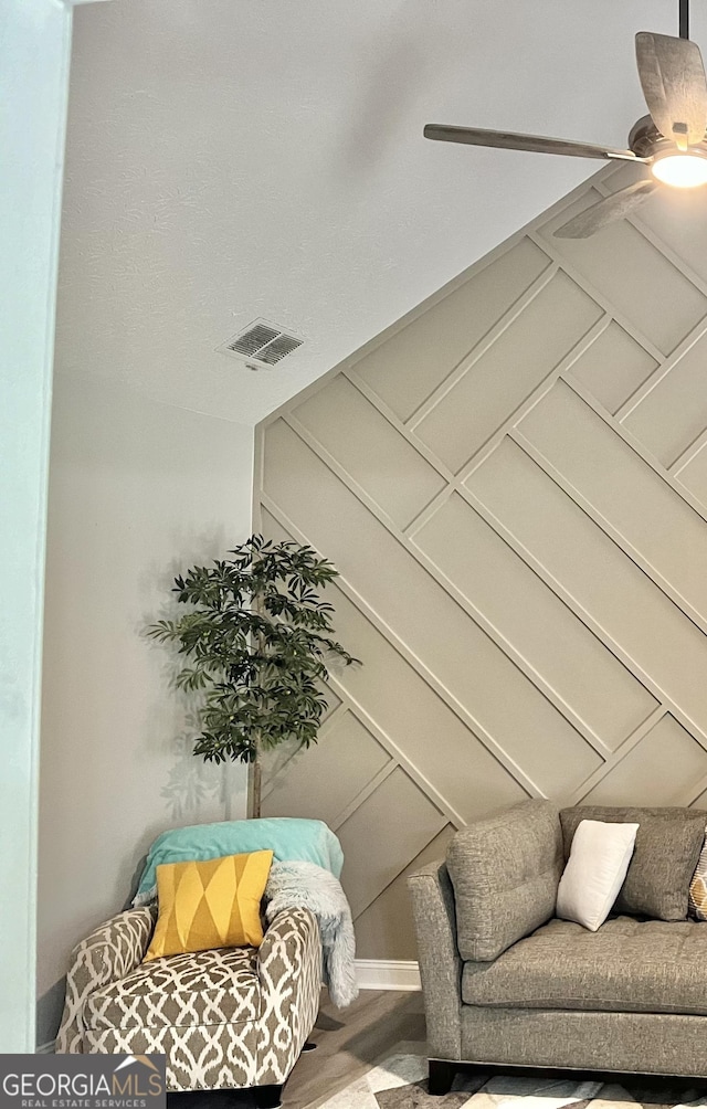 sitting room featuring ceiling fan