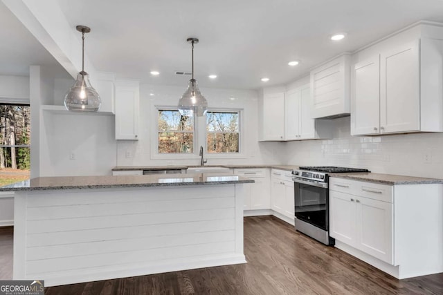 kitchen featuring white cabinetry, hanging light fixtures, and stainless steel range with gas stovetop