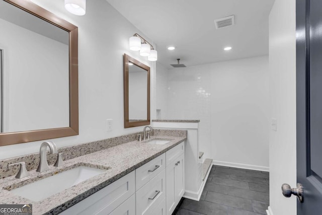 bathroom featuring vanity and a shower