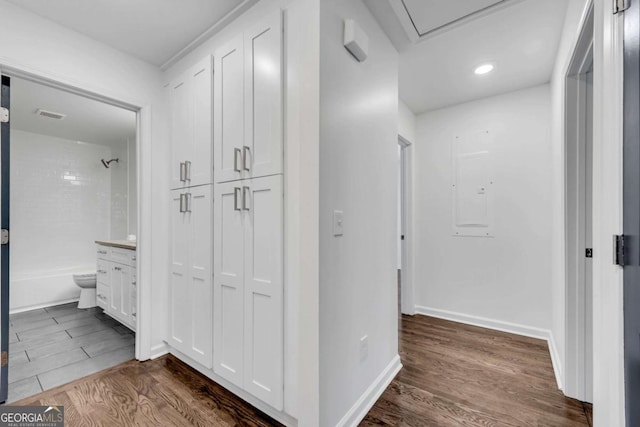 hallway with electric panel and dark wood-type flooring