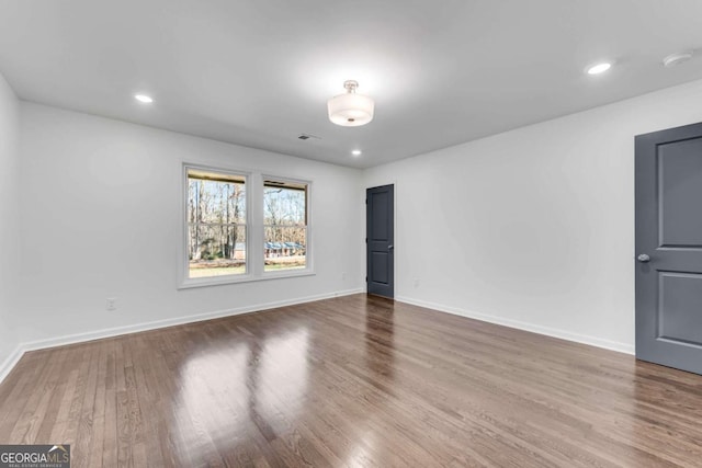 unfurnished room featuring hardwood / wood-style flooring