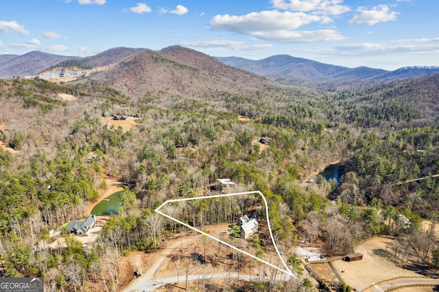 aerial view featuring a forest view and a mountain view