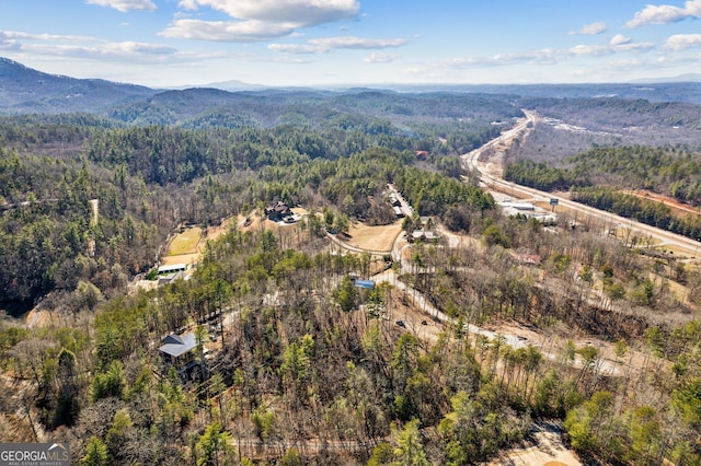 birds eye view of property featuring a mountain view and a forest view