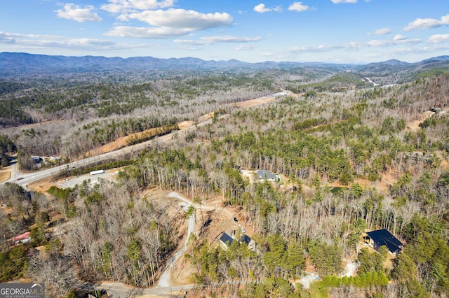 aerial view featuring a forest view and a mountain view