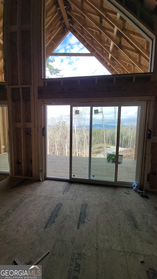 unfurnished living room featuring visible vents and lofted ceiling