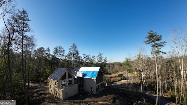 exterior space featuring a forest view