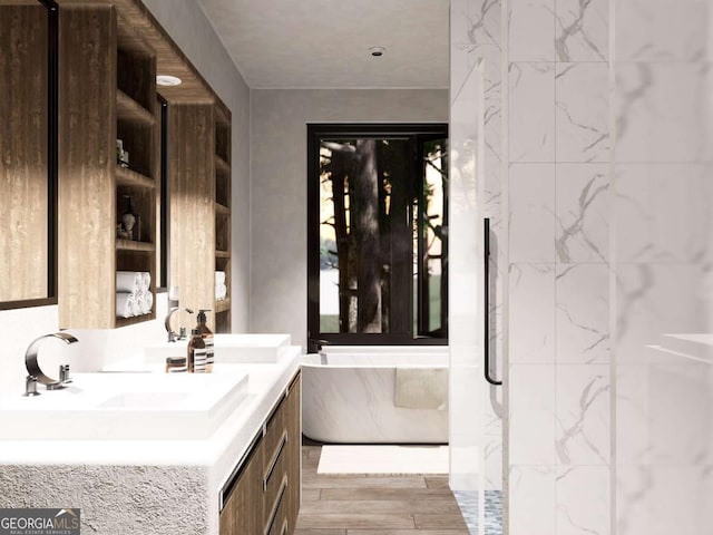 bathroom featuring double vanity, a freestanding tub, wood finished floors, and a sink